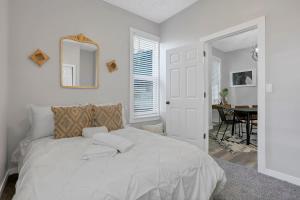 a bedroom with a bed with a mirror and a table at Housepitality - The Olive - 4 BR 2 Bath in Columbus