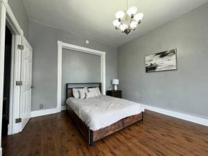 a bedroom with a bed and a chandelier at Spacious Downtown Home SJ in San Jose