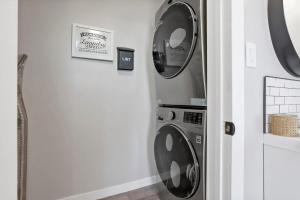 a washer and dryer in a corner of a room at Housepitality - The Olive - 4 BR 2 Bath in Columbus