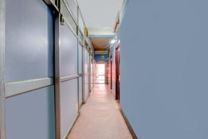 an empty hallway in a building with a long corridor at SPOT ON City Lodge Ganeshguri in Dispur