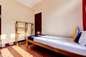a bedroom with a bed in a room at SPOT ON City Lodge Ganeshguri in Dispur