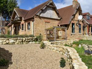 a large brick house with a stone path in front of it at Bramley Cottage in Langley