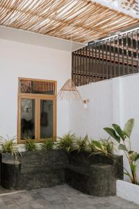 a lobby with potted plants in a building at Nagi cottage in Kinh Dinh