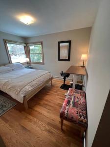 a bedroom with a bed and a desk in it at The Badger House ~ Newly Remodeled Home ~ Rib Mountain in Wausau