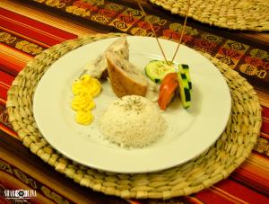a plate of food with rice and vegetables on a table at Hotel San Andrés in San Andrés