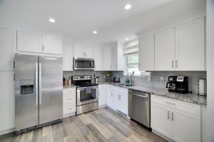a kitchen with white cabinets and stainless steel appliances at SummitTerrace Comfy Getaway-Centralized Location in East Stroudsburg