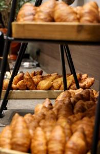 a bunch of pastries on display in a bakery at Leonardo Royal Hotel Amsterdam in Amsterdam