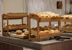 a display of different types of pastries on a counter at Leonardo Royal Hotel Amsterdam in Amsterdam