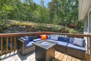 a patio with a couch and a table on a deck at SummitTerrace Comfy Getaway-Centralized Location in East Stroudsburg