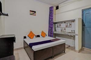 a bedroom with a bed and a sink in it at OYO Hotel Jmd Residency in Shahdara