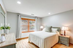 a bedroom with a bed and a window at Blue Ridge Mountain Condo with Golf Course Views! in Burnsville