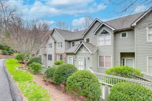 a gray house with a white fence and bushes at Blue Ridge Mountain Condo with Golf Course Views! in Burnsville