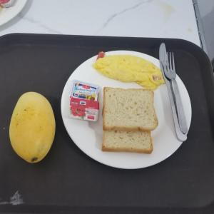 a white plate of food with a sandwich and a banana at Top One Backpacker Hostel in Vientiane