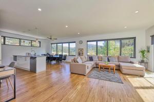 a living room with a couch and a table at The Gorge Townhouse, stunning home & location! in Royal Park