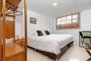 Postel nebo postele na pokoji v ubytování Hotel Gran Boutique Sabana