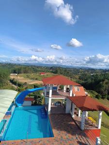 an aerial view of a swimming pool and a house at Finca con Piscina Privada/Jacuzzi/Asador in San Vicente