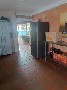 a kitchen with a black refrigerator in a room at Finca con Piscina Privada/Jacuzzi/Asador in San Vicente