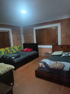 a room with two beds and a couch in it at Finca con Piscina Privada/Jacuzzi/Asador in San Vicente
