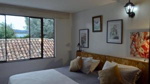Postel nebo postele na pokoji v ubytování Hotel Gran Boutique Sabana