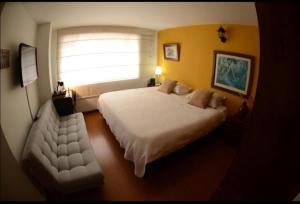 Postel nebo postele na pokoji v ubytování Hotel Gran Boutique Sabana