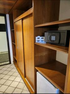 a kitchen with a microwave sitting on a shelf at Hisort Piramide Natal in Natal