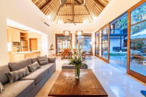 a living room with a couch and a table at Majestic 3 BR Private Pool Villa NE18 in Jimbaran