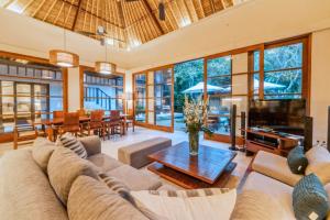 a living room with a couch and a table at Majestic 3 BR Private Pool Villa NE18 in Jimbaran