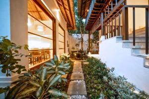 a building with a courtyard with plants in it at Majestic 3 BR Private Pool Villa NE18 in Jimbaran