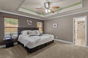 a bedroom with a bed and a ceiling fan at Keller Charm-Near Bear Creek Park & Stadiums,Pool in Keller +34 photos