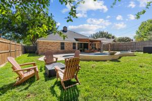 a yard with three rocking chairs and a house at Keller Charm-Near Bear Creek Park & Stadiums,Pool in Keller