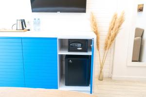 a kitchen with a blue and white counter with a dishwasher at Seagull Hotel Batumi in Batumi
