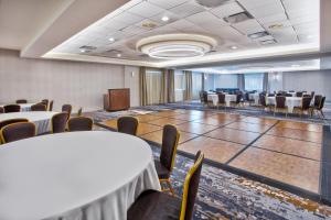 a conference room with tables and chairs and a podium at Crowne Plaza Chicago-Northbrook, an IHG Hotel in Northbrook
