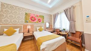 Postel nebo postele na pokoji v ubytování Sao Vang Hotel