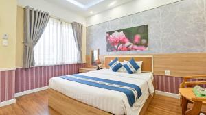 Postel nebo postele na pokoji v ubytování Sao Vang Hotel