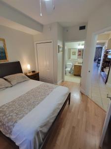 a bedroom with a bed and a hallway with a bathroom at Lakeview Condo Hotel near Disney in Orlando