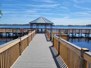 a wooden pier with a gazebo on the water at Lakeview Condo Hotel near Disney in Orlando