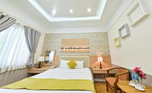 Postel nebo postele na pokoji v ubytování Sao Vang Hotel