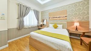 Postel nebo postele na pokoji v ubytování Sao Vang Hotel