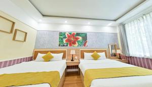 Postel nebo postele na pokoji v ubytování Sao Vang Hotel