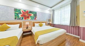 Postel nebo postele na pokoji v ubytování Sao Vang Hotel
