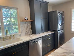 a kitchen with a sink and a washing machine at Guest house with private entry and large pool in Los Angeles
