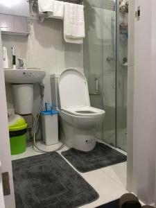 a bathroom with a toilet and a sink and a shower at Brand new and fully furnished home away from home! in Manila