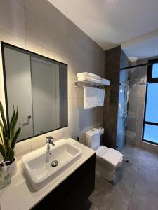 a bathroom with a sink and a toilet at Bukit Bintang Axon 3R2B HiFloor wt Parking in Kuala Lumpur