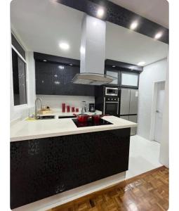 a kitchen with a black and white counter top at Renewed apt in Altamira, the heart of Caracas in Caracas