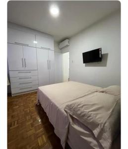 a bedroom with a bed and a flat screen tv at Renewed apt in Altamira, the heart of Caracas in Caracas
