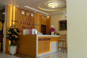 a lobby of a hotel with a reception counter at Tân Hiệp Hotel in Bùi Tiếng
