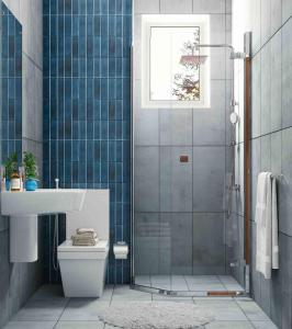 een badkamer met een douche, een toilet en een wastafel bij SANTORINI BLUE LUX in Negombo