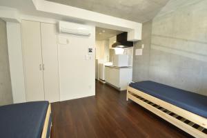 Habitación pequeña con litera y cocina en Enzo iogi, en Tokio