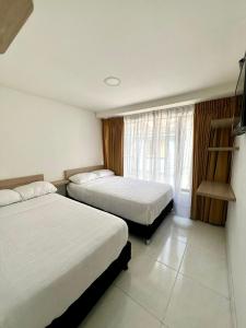 מיטה או מיטות בחדר ב-Hotel Adel