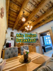 a kitchen and dining room with a table and chairs at Hermannstadt House in Sibiu